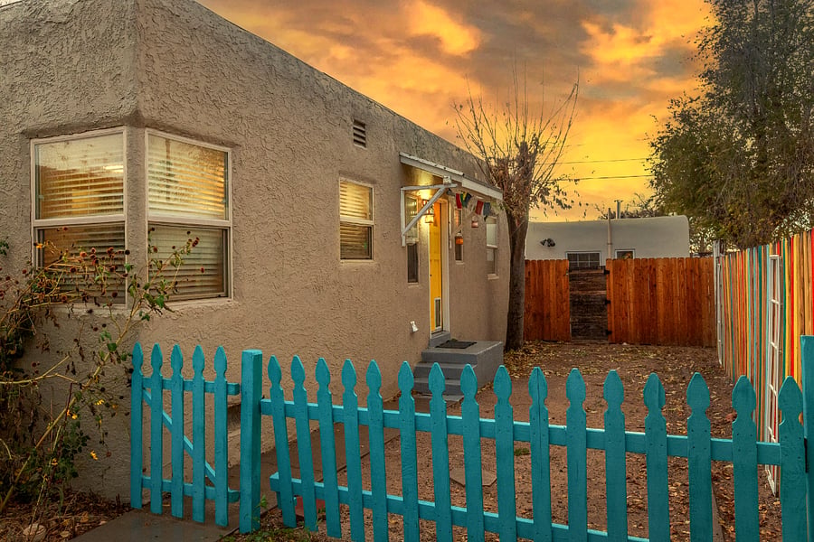Side yard -- the doggy door leads to this space. The gate swings open if you'd like to park your car behind it as well.