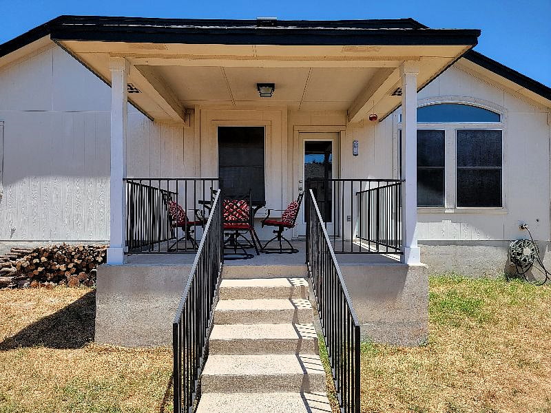 Fenced in backyard with patio
