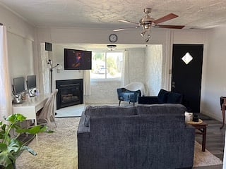 Desk and chair with 2 monitors for working at home in living room
