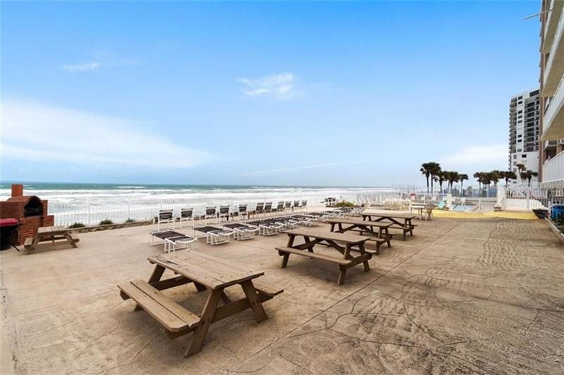 Relax to the sights and sounds of the ocean on the large community deck with brick barbeque grill, loungers, and tables.