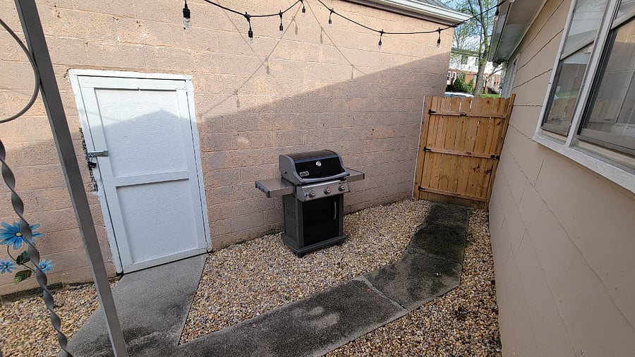 Private outdoor courtyard with Weber grill and multi colored LED lighting