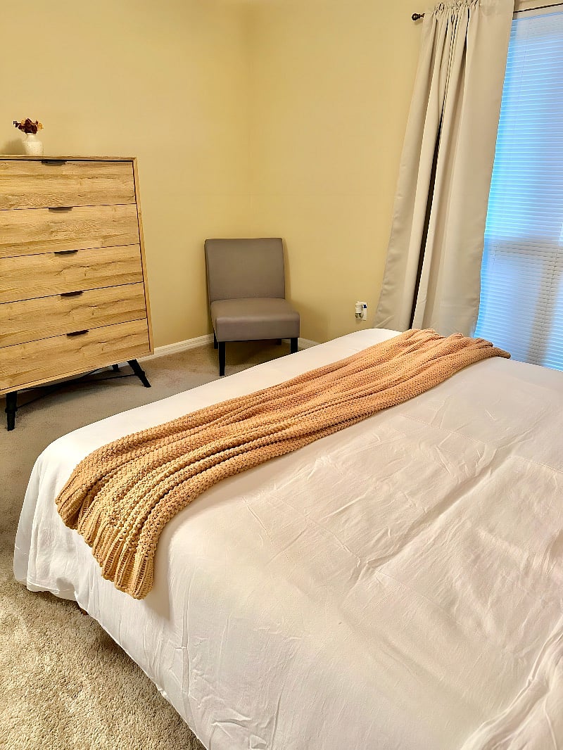 Bedroom equipped with blackout curtains. 