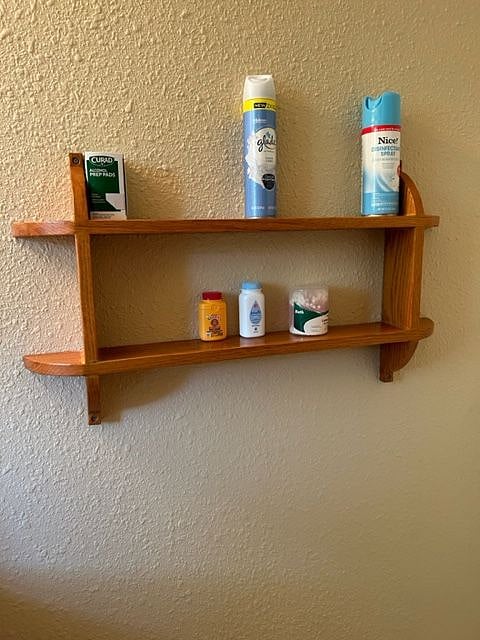 Wall shelf behind bathroom door
