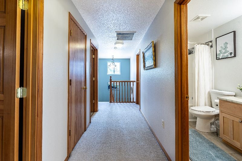 Upstairs hallway with office space and laundry to the left, and the Mt. Hood Room, shared bathroom and Mt. Denali Room to the right.
