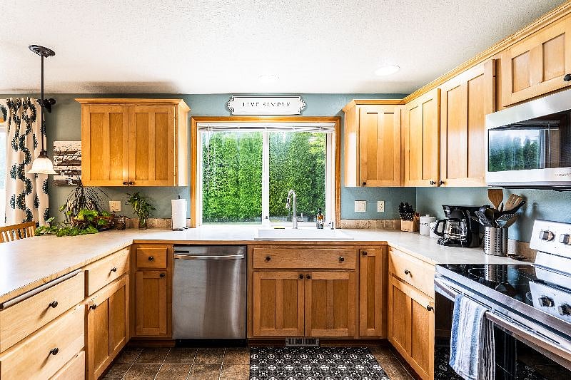 Kitchen and dining area, view of fully hedged and private backyard.
