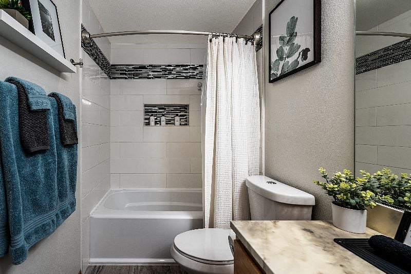 Shower and bath tub in shared bathroom.
