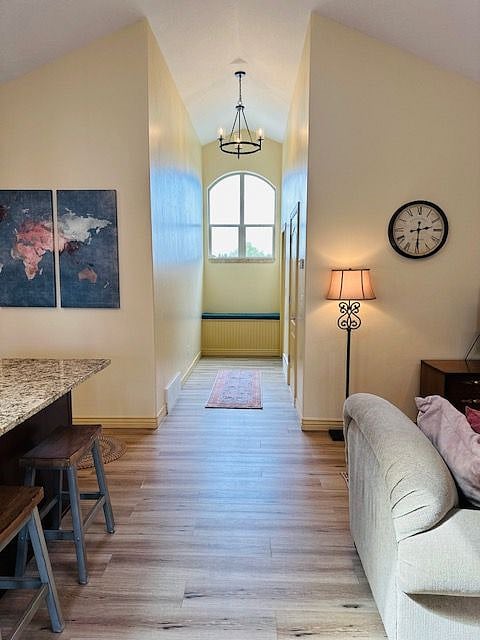Hallway, towards the second room and hall bathroom with laundry.  Tall ceilings with lots of natural light