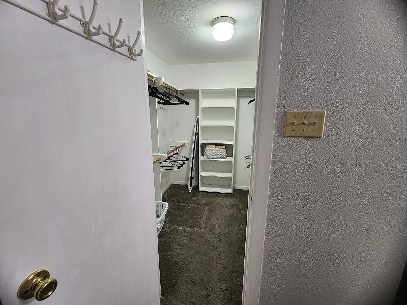Spacious walk-in closet in the primary bedroom with plenty of room for clothes, shoes, and more.
