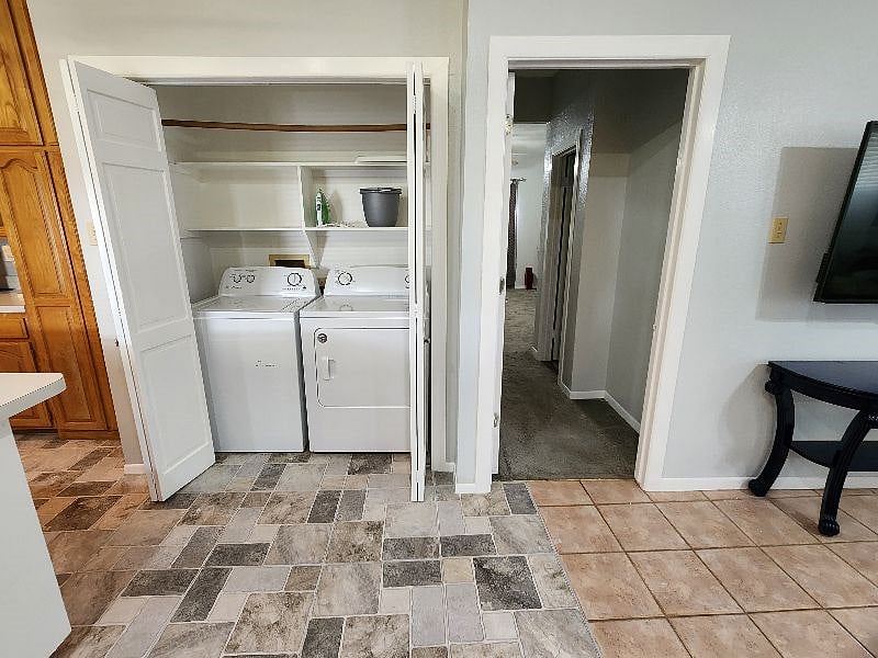 Full-size washer and dryer conveniently located just outside the primary bedroom.