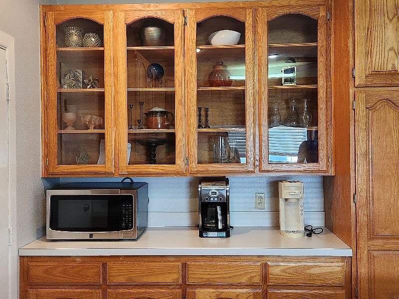 Extra counter space for a coffee station, daily essentials, or a convenient catch-all, with additional storage below. Drip and single-serve coffee makers provided.