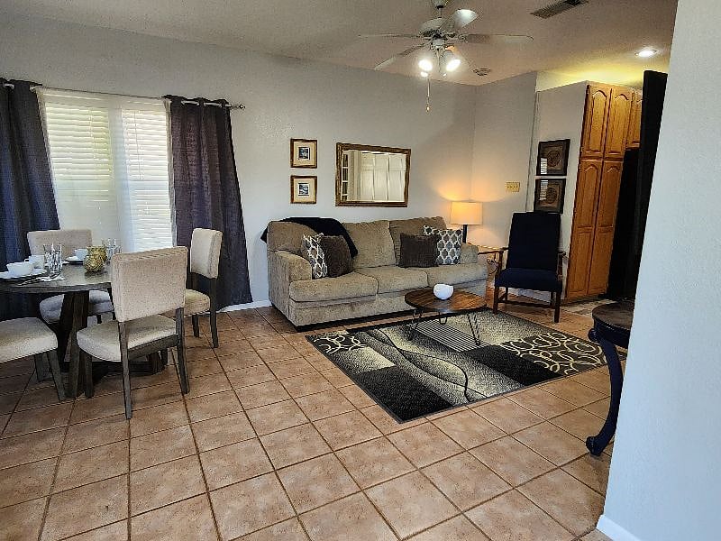 Open floor plan connects the furnished dining and living areas, creating a comfortable space for everyday living.