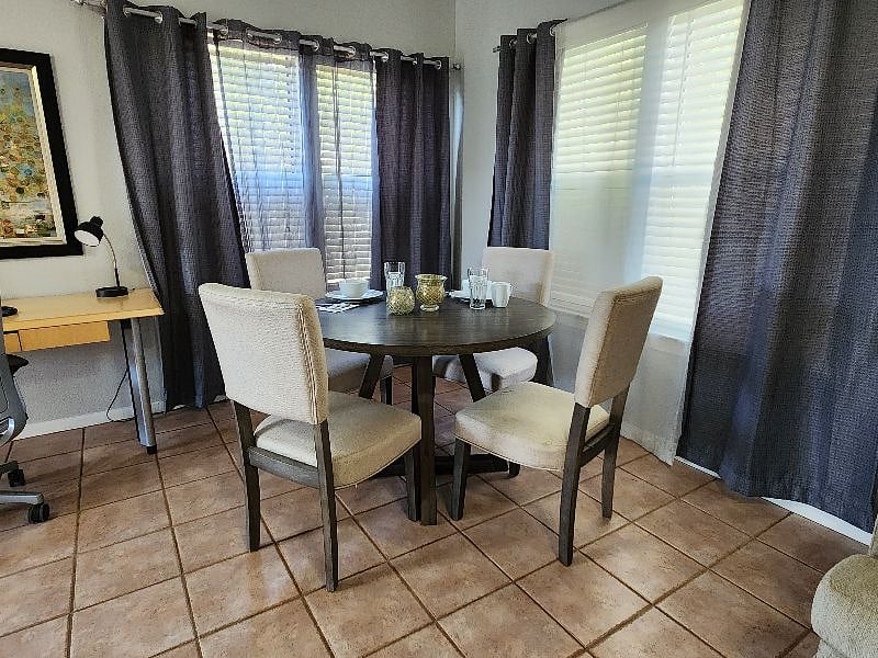 Dining table comfortably seats four, with dishware, glassware, and utensils for four already provided.