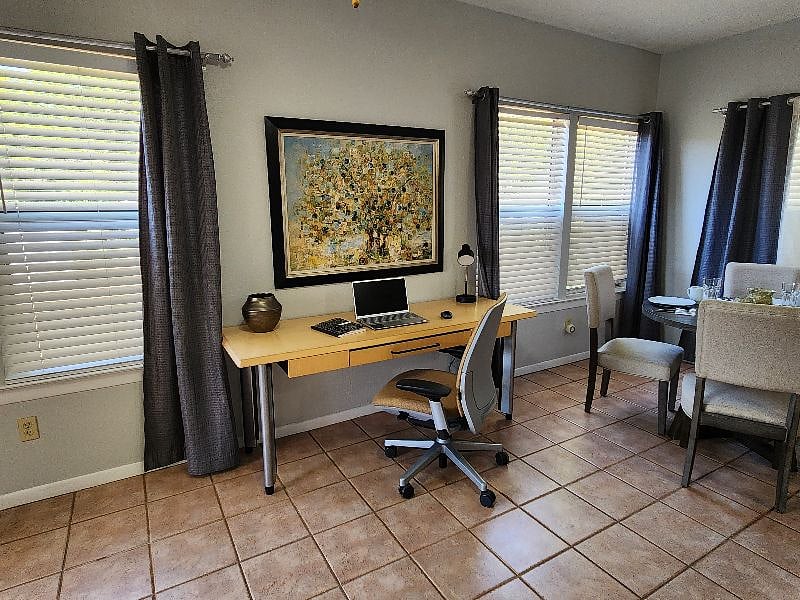 Comfortable, dedicated workspace with an office-quality desk and chair ready for work-from-home days. (Laptop shown for reference only.)