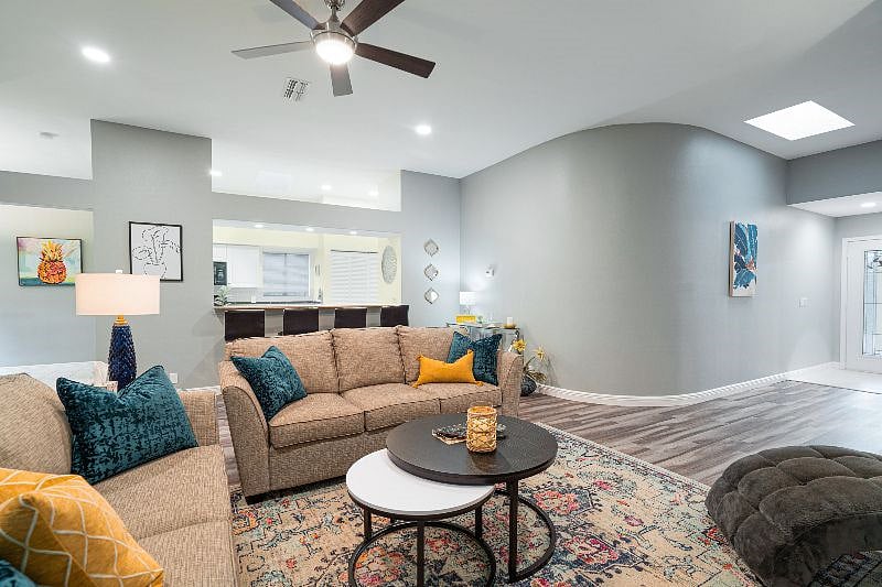 Spacious and Bright Living room Featuring High Ceilings with Skylight Windows 
