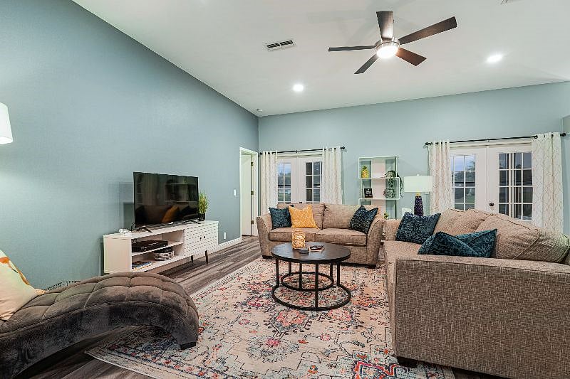 Spacious and Bright Living room Featuring High Ceilings with Skylight Windows 