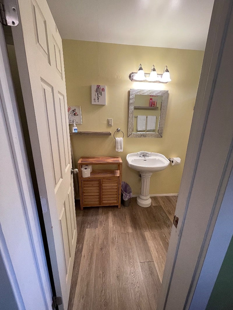 Entrance to bathroom. Tub and toilet to right and washer/dryer on left. Sparkling clean of course.
