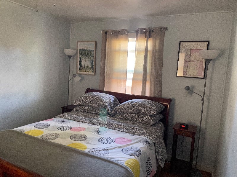 Bedroom. Queen size bed with end tables, alarm clock and not pictured is closet area, dresser and tv.