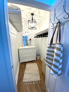 Walk in closet with second dresser.