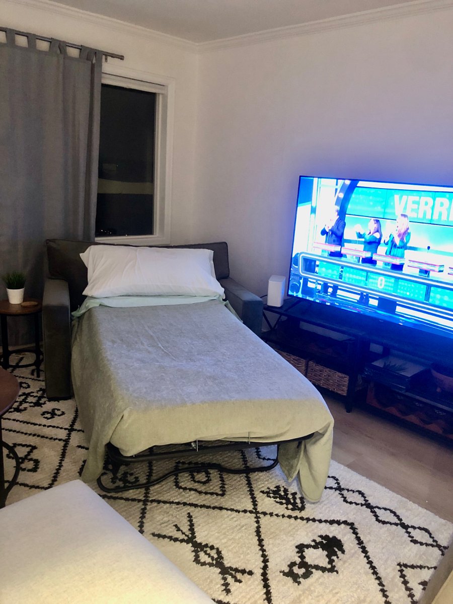 Oversized living room chair turns into single bed for guest.