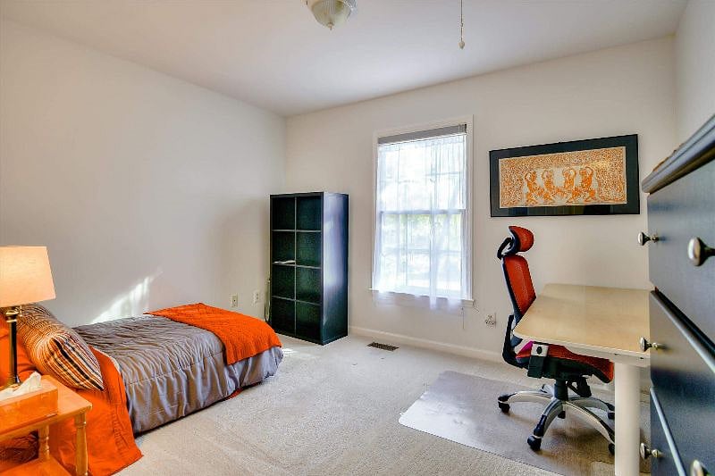 Second office with sit/stand desk and comfortable chair.