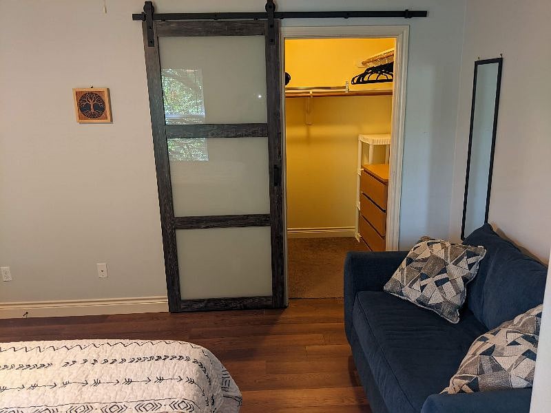 Large walk-in closet behind barn door