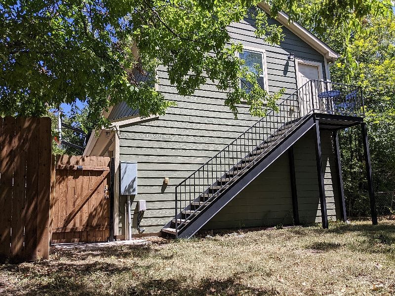 Entry gate and stairway towards detached garage apartment.