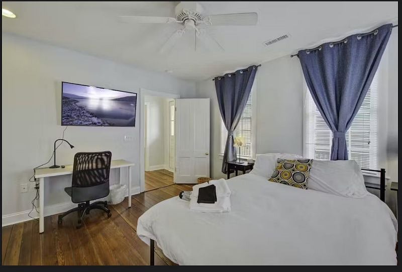 Bright and relaxing upstairs front bedroom, thoughtfully furnished with comfortable bedding and ample storage for a restful stay.