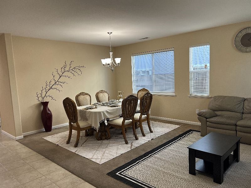 Formal dining/living room. Additional leather couches and dinner table here