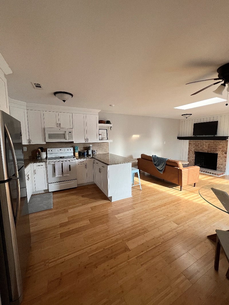 Lovely open concept kitchen and living room floor plan with high ceilings.