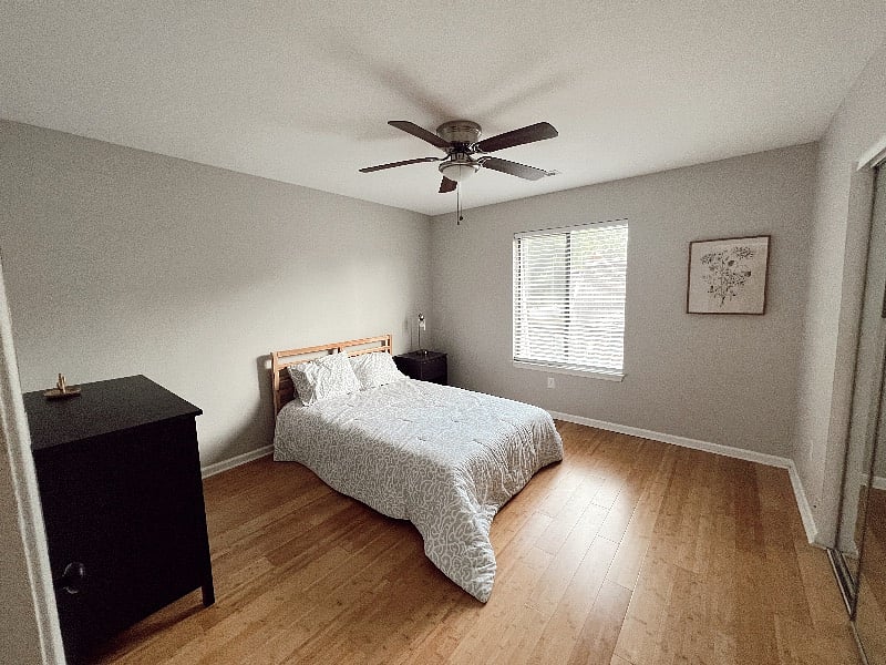 Bedroom 2 has a modern full size bed, night stand, and closet.