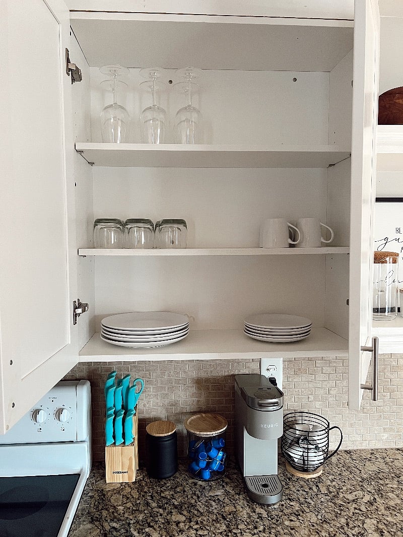 All new granite countertops and cabinets stocked with glassware, kitchen utensils, and coffee supplies.