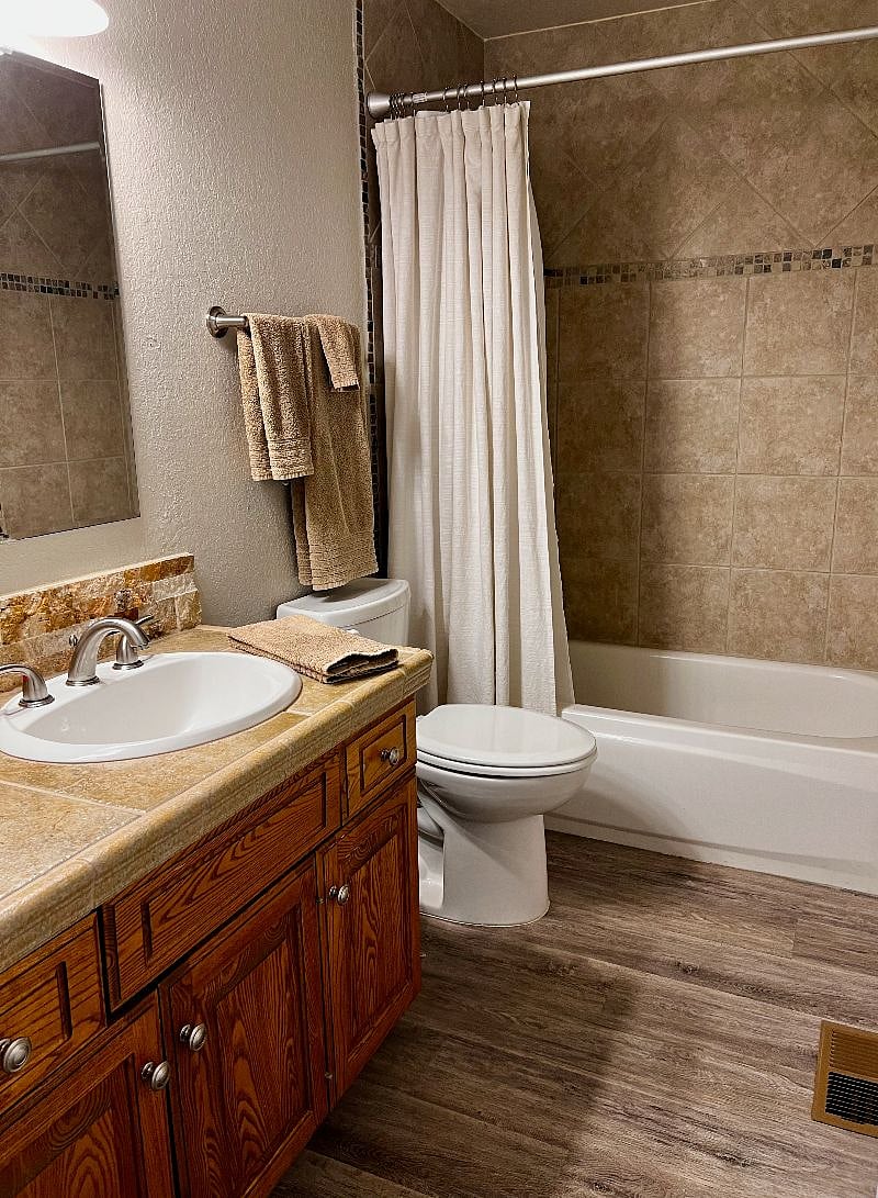 Bathroom with hairdryer, curling iron, and supplies to get you started.