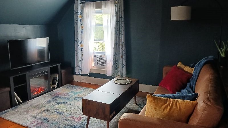 Living room with lift up coffee table and a sofa table that has usb ports and outlets
