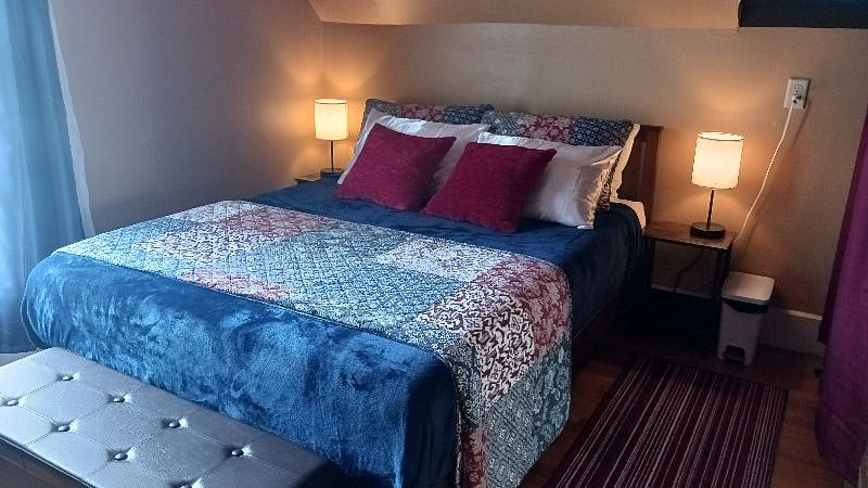 Bedroom with touch lamps (usb ports and outlet on sides of lamps)