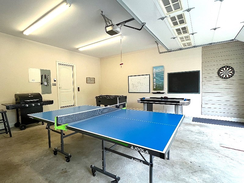 Game room with ping pong, air hockey, darts, corn hole, and foosball