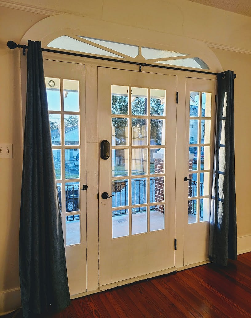 Interior view of front doors with architectural detail and operational side lights.