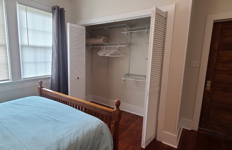 Queen bedroom with large closet with adjustable shelving.