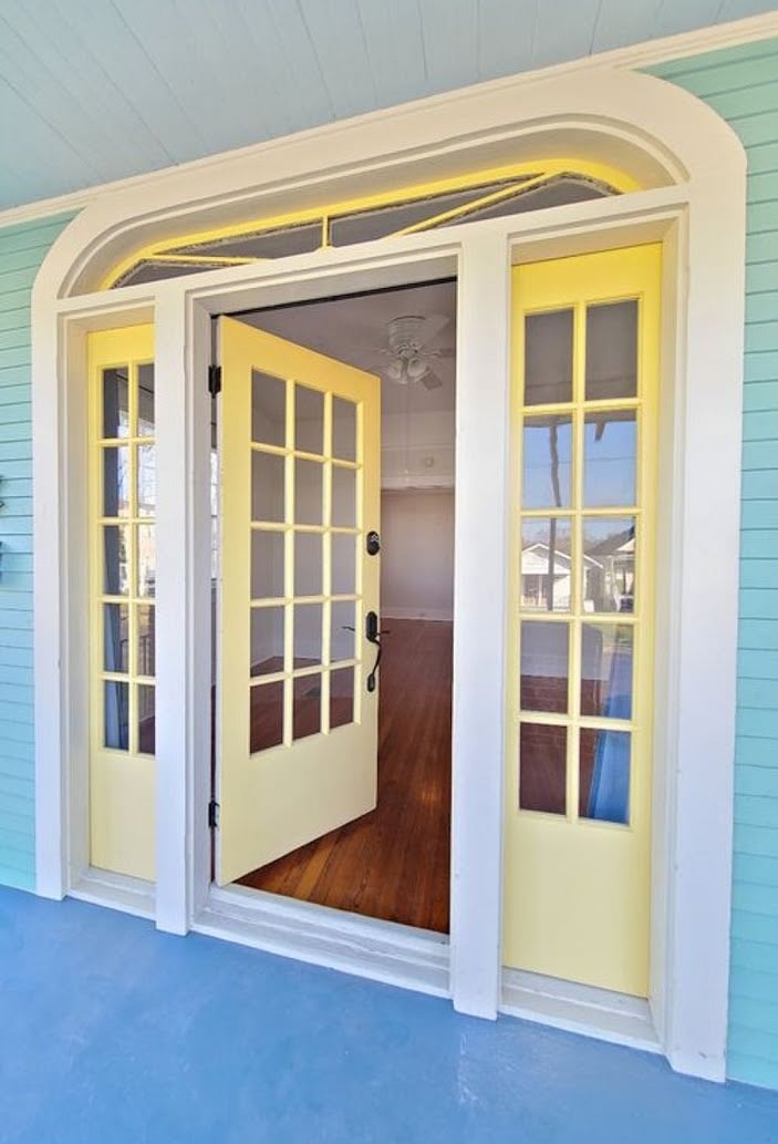 Exterior view of front doors with architectural detail. Sidelights are operational.