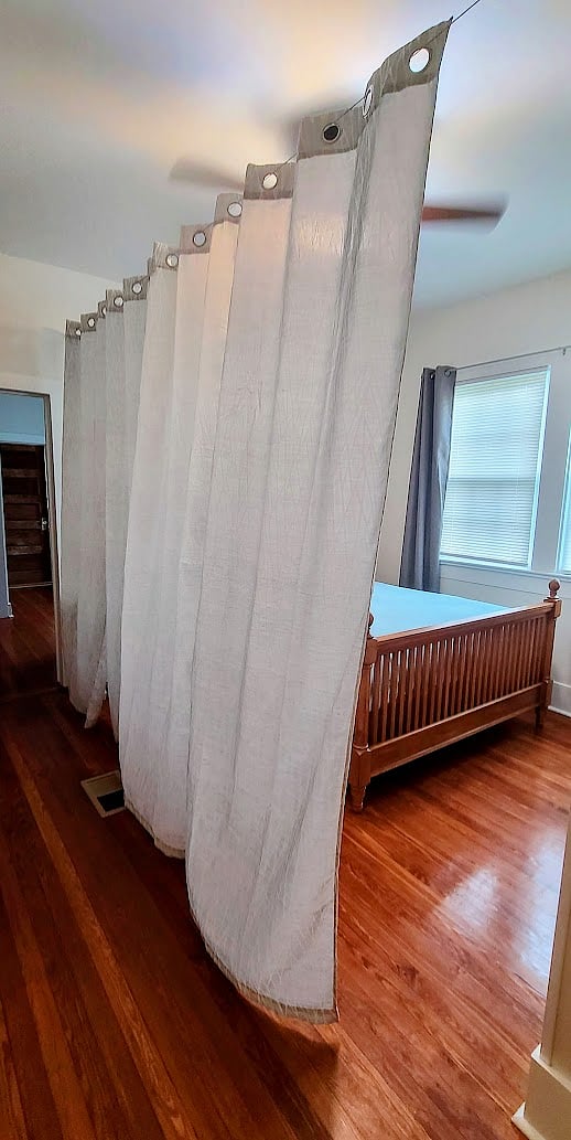 Moveable curtain creates visual privacy in Queen Bedroom.