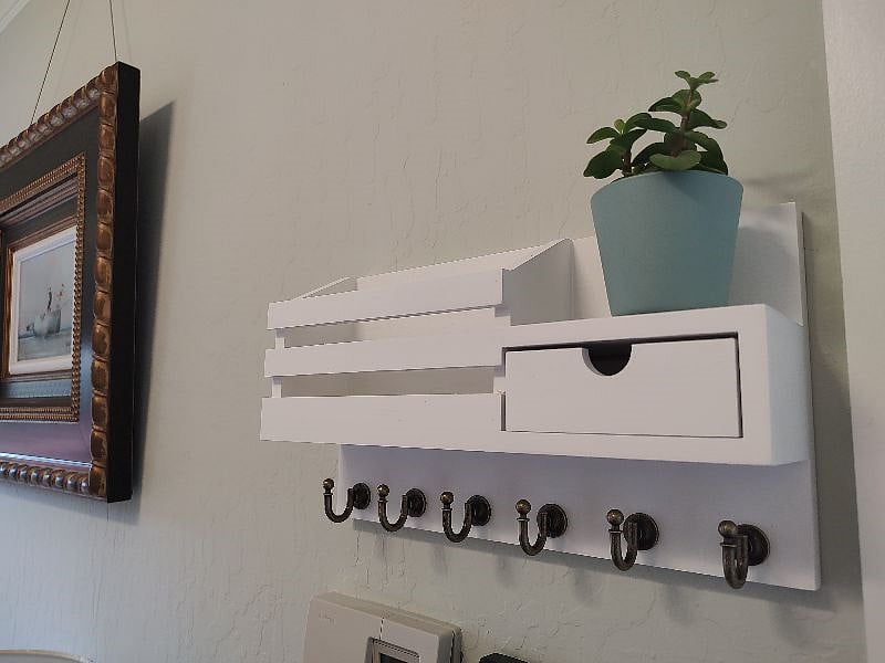 A cubby for keys, letters and glasses, etc.  A cute succulent plant added for a touch of whimseys.
