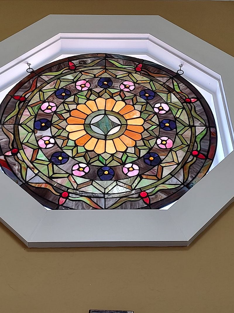 Stained glass nestled within one of the octagonal vaulted windows.