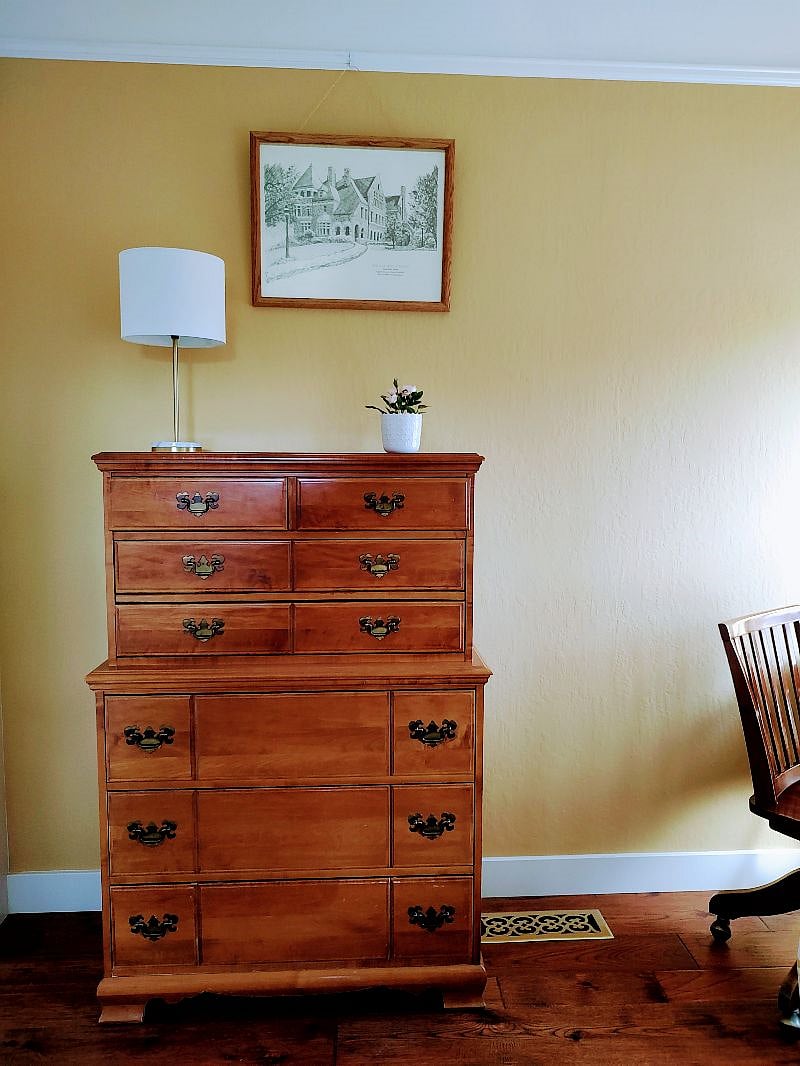 Wooden dresser with lamp.
