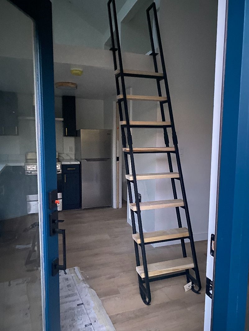 Stairs pull out for use and can be lifted up and they hang straight up and down to make for better use of space.