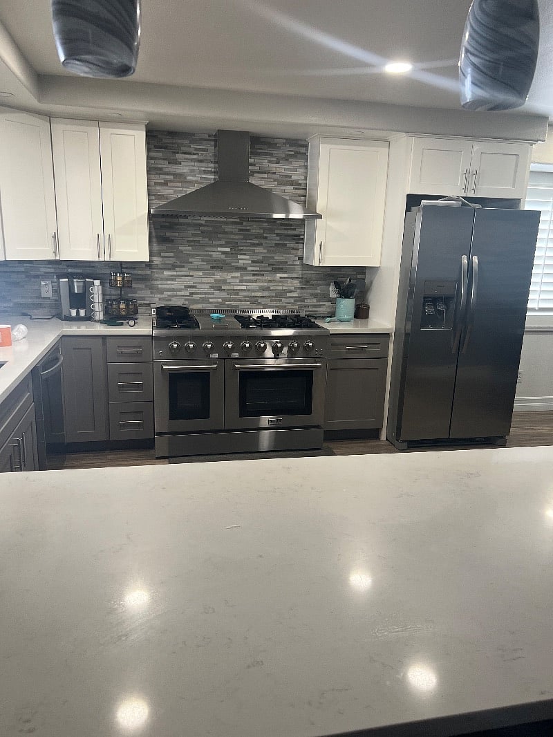 Beautiful remodeled kitchen with a 48" stove range with two ovens. Range is gas and ovens are electric.