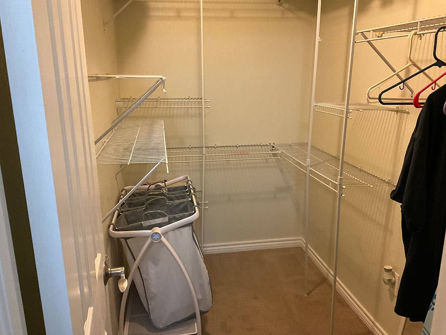 Closet in bathroom with ironing board and iron