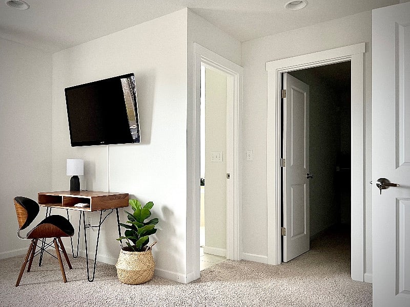 Primary bedroom with desk, tv & walk-in closet