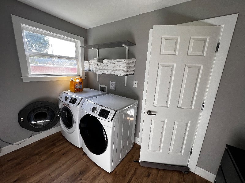 Laundry room with Samsung front loading washer and dryer units