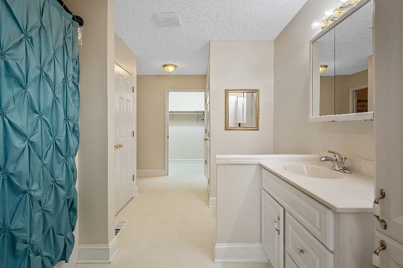 Large bathroom with bathroom closet, cloths closet and laundry room.