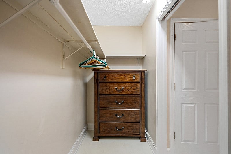 Walk-in closet with dresser.