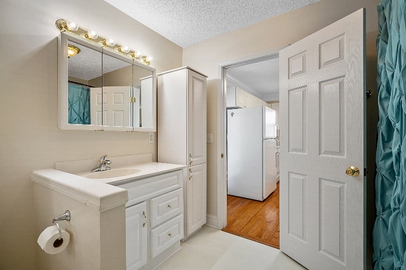 Bathroom view, extra storage next to the sink.